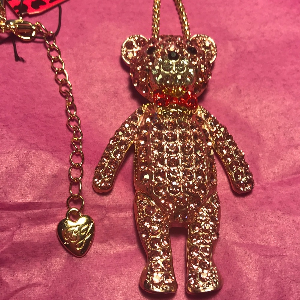 pink bear with a red bow tie